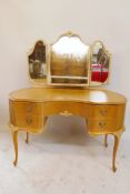A vintage bleached wood kidney shaped kneehole dressing table with triptych mirror and five drawers,