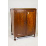 An Edwardian mahogany record cabinet with fitted interior, raised on turned supports, 18" x 24" x