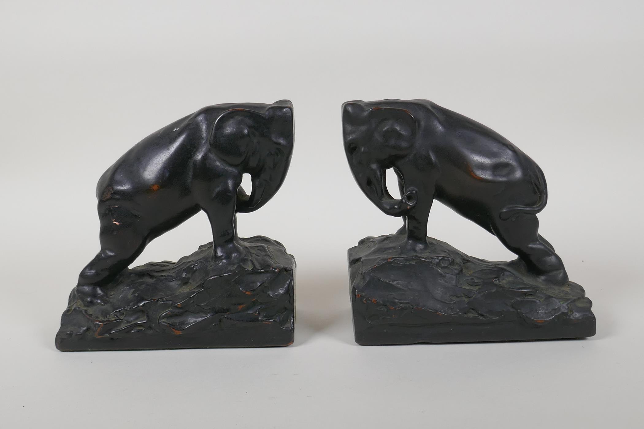A pair of filled and bronzed copper elephant bookends, 6" long, 6" high