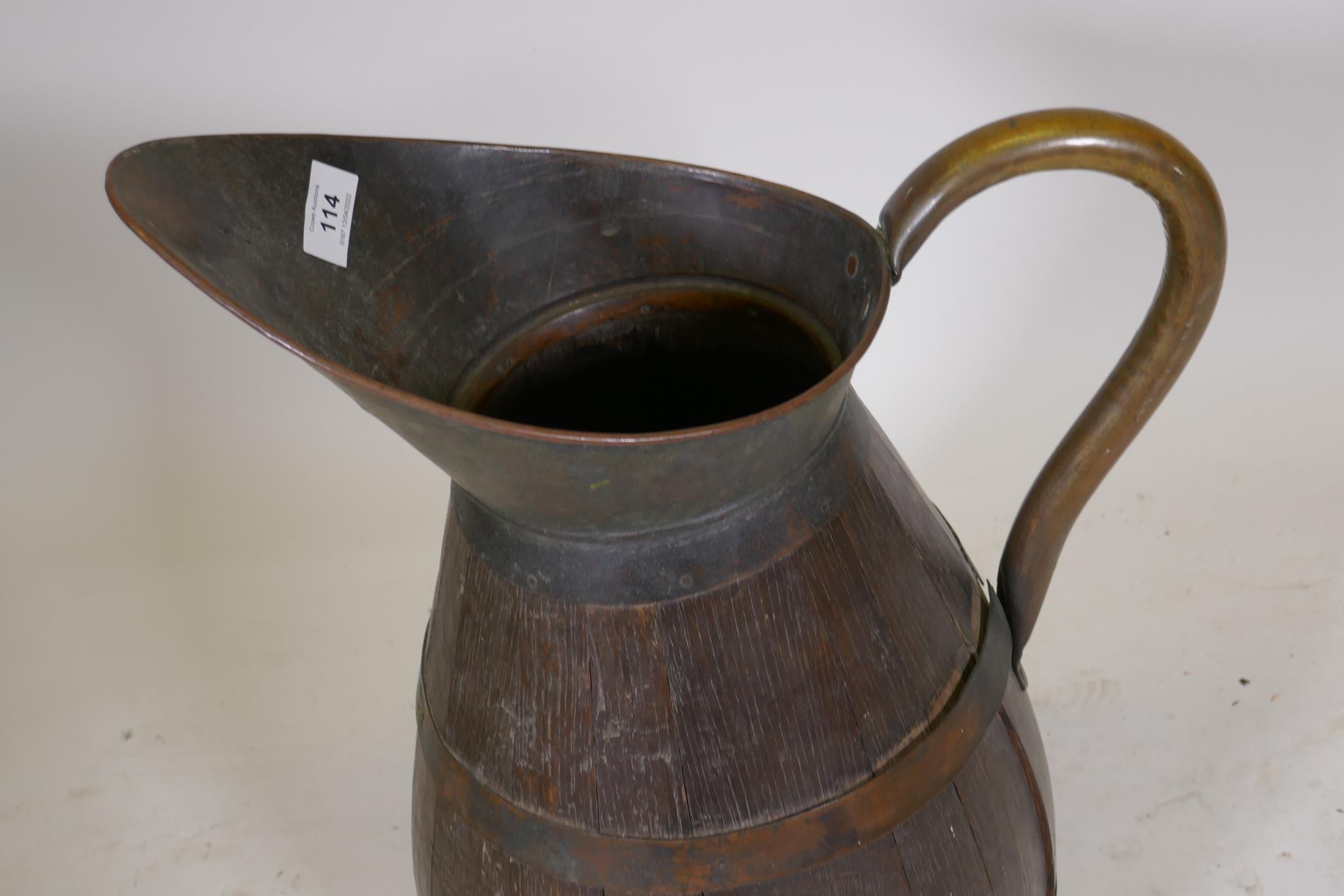 An antique coopered oak pitcher with brass handle, 23" high - Image 2 of 3