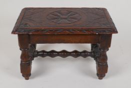 A small oak footstool with carved top and bobbin turned legs and stretcher, 11" x 7" x 6½"