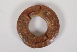 A Chinese archaic carved hardstone puzzle ring, 4½" diameter