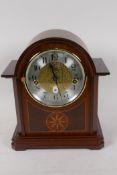 A new German made Westminster chimes clockwork mantel clock with silvered dial and Arabic numerals