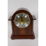 A new German made Westminster chimes clockwork mantel clock with silvered dial and Arabic numerals