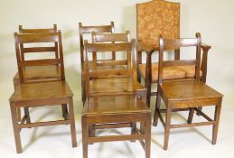 A harlequin set of six oak bar back chairs with solid seats, and an Arts and Crafts open armchair