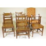 A harlequin set of six oak bar back chairs with solid seats, and an Arts and Crafts open armchair