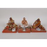 Three Indian painted and plastered papier mache  seated figures, AF, largest 4" high