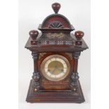 A German walnut cased mantel clock with brass embellished architectural case with striking movement,