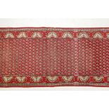 A vintage Iranian red ground runner with a mir design from the Tabriz region, 39" x 96"