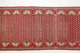 A vintage Iranian red ground runner with a mir design from the Tabriz region, 39" x 96"