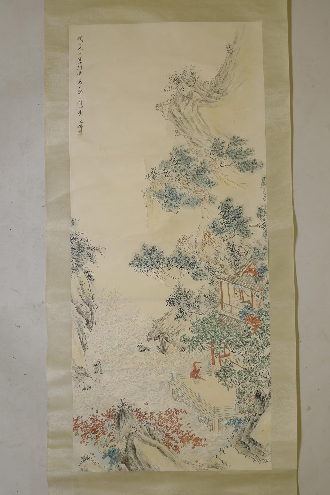 A Chinese watercolour scroll depicting figures in a riverside dwelling, 21½" x 49"