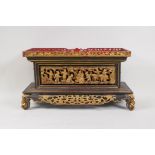 An antique Chinese carved and pierced, gilt and lacquer wood stand decorated with industrious