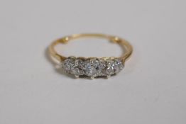 An antique 18ct yellow gold five stone diamond ring, one stone replaced with glass, the ring with