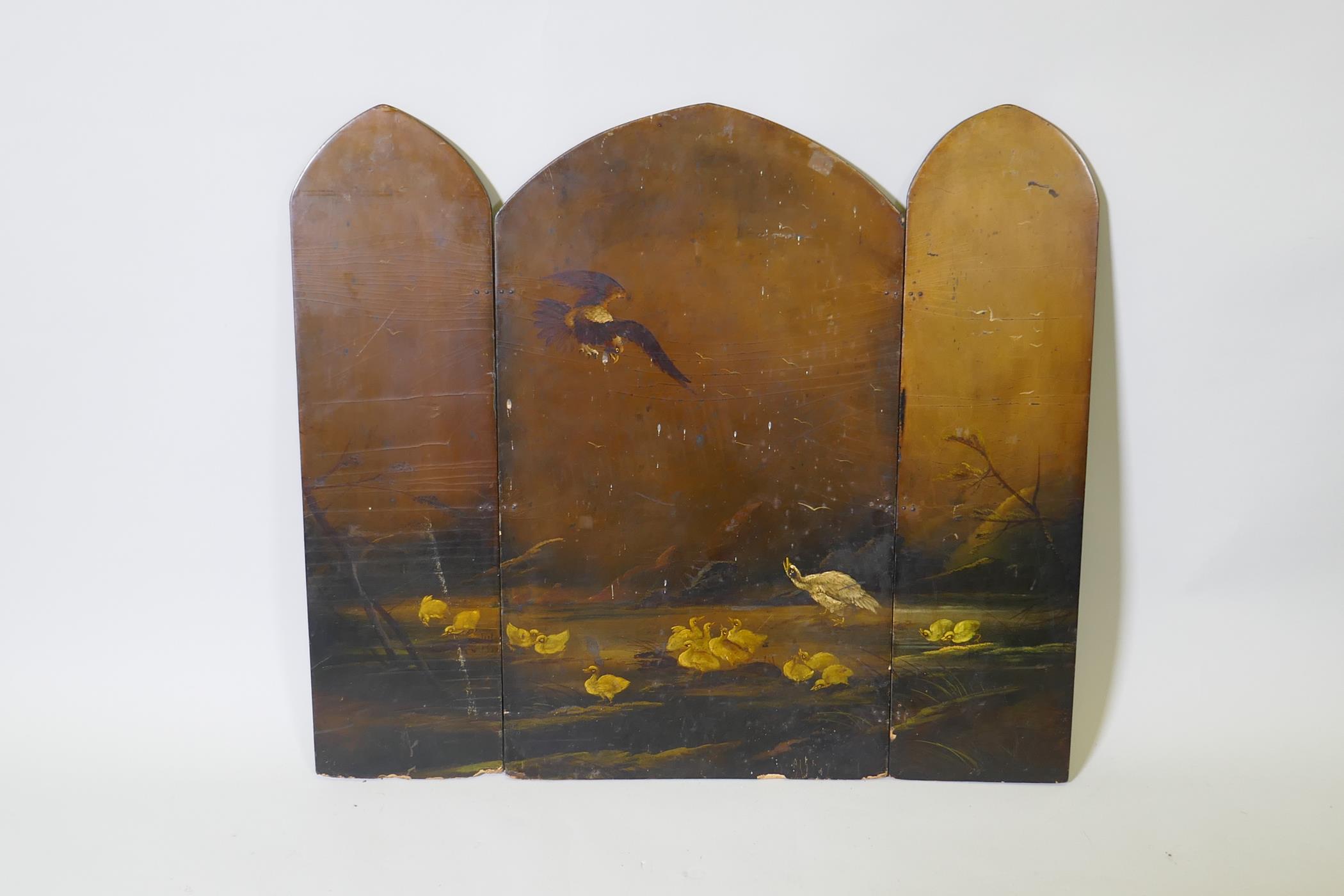 A Victorian papier mache two fold fire screen, decorated with a hawk attacking ducks, 26" x 30"