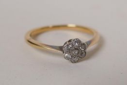 A yellow metal ring set with seven diamonds, tested as gold, 2.1g