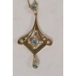 A 15ct gold pendant set with pearls and pale blue gemstones, on a 15ct gold chain, 5.1g gross