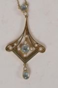A 15ct gold pendant set with pearls and pale blue gemstones, on a 15ct gold chain, 5.1g gross