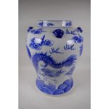 A Chinese blue and white porcelain floor vase decorated with dragons chasing the flaming pearl, 19½"