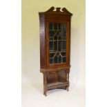 A Georgian mahogany corner display cabinet, with astragal glazed door below a dentil cornice and