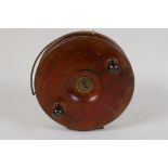 A vintage mahogany and brass Starback fishing reel, 7" diameter