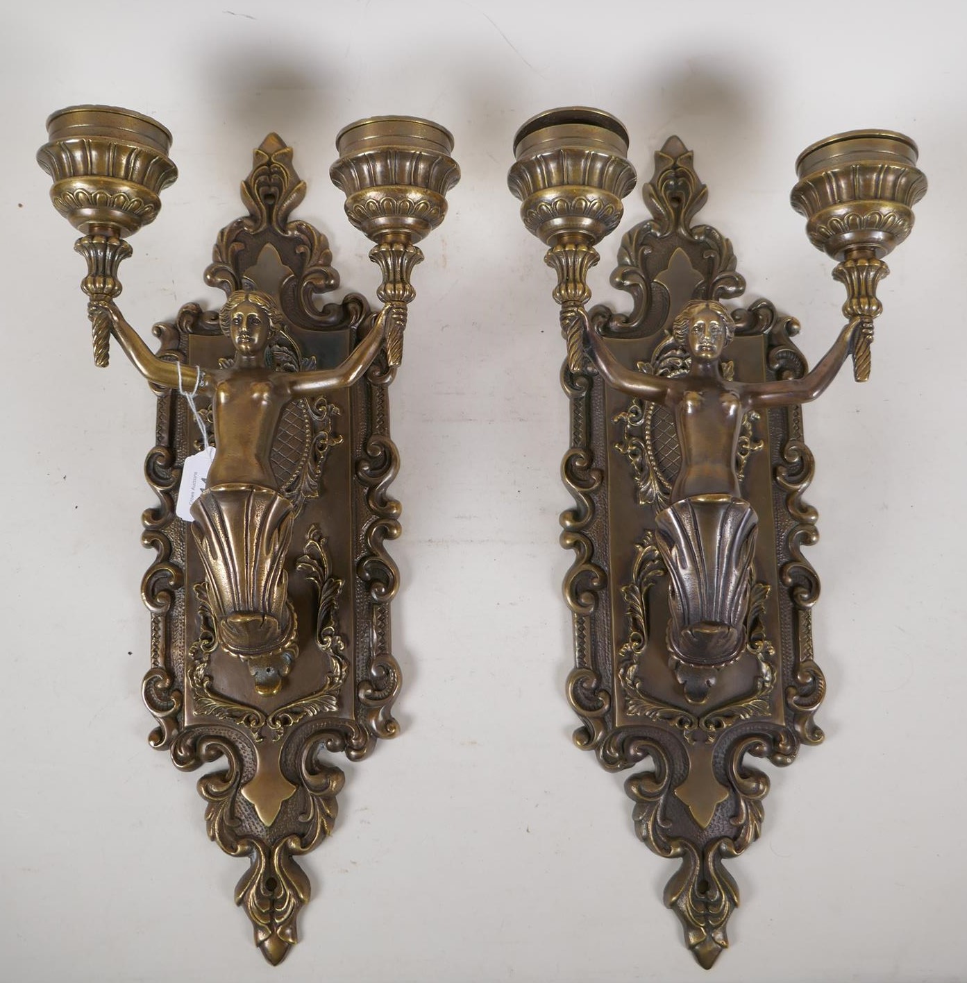 A pair of bronze two branch wall sconces in the form of mermaids, 9" x 19"