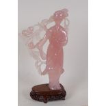 A carved rose quartz figure of a Chinese lady, on a hardwood stand, 8" high