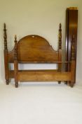 A mahogany bed frame, with arched head board and turned posts, 60" wide, 66" high