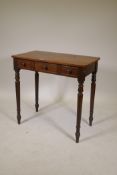 A C19th mahogany side table with three false drawers, raised on turned supports, 31" x 17" x 30"