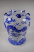 A Chinese blue and white porcelain floor vase decorated with dragons chasing the flaming pearl, 19½"