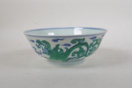 A Ming style blue and white porcelain rice bowl with green enamelled dragon decoration, Chinese