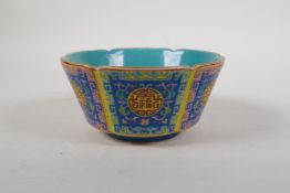 A polychrome porcelain steep sided bowl with a lobed rim, decorated with the auspicious longevity