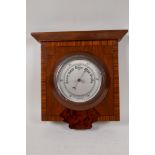 An aneroid barometer in an Art Deco specimen wood case, 11½" x 9"