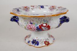 A Masons Ironstone pedestal bowl with two blue and gilt handles and overall floral decoration, 7"