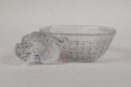 A Chinese moulded glass bowl with dragon mask decoration and raised character inscription, 6" x 3½"