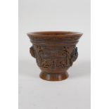 A Chinese faux horn libation cup with raised kylin decoration, impressed mark to base, 4" diameter