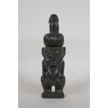 An African carved hardstone fertility figure, 10" high