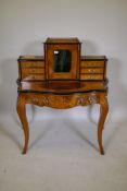 A Victorian inlaid figured walnut ormolu mounted bonheur de jour, with ebonised decoration, the