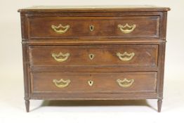 An C18th French oak commode, the three drawers with moulded edges and original brass handles,