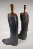 A pair of vintage leather riding boots with hardwood jacks, size 10