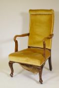 A Victorian open arm walnut armchair, with high back and scroll arms, raised on cabriole supports