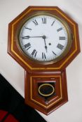 An American drop dial wall clock with painted decoration, white dial and Roman numerals, 21" long