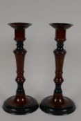 A pair of bronze candlesticks with wood effect patinated finish, 10" high