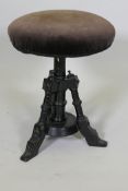 An Aesthetic Movement ebonised revolving piano stool, 21" high