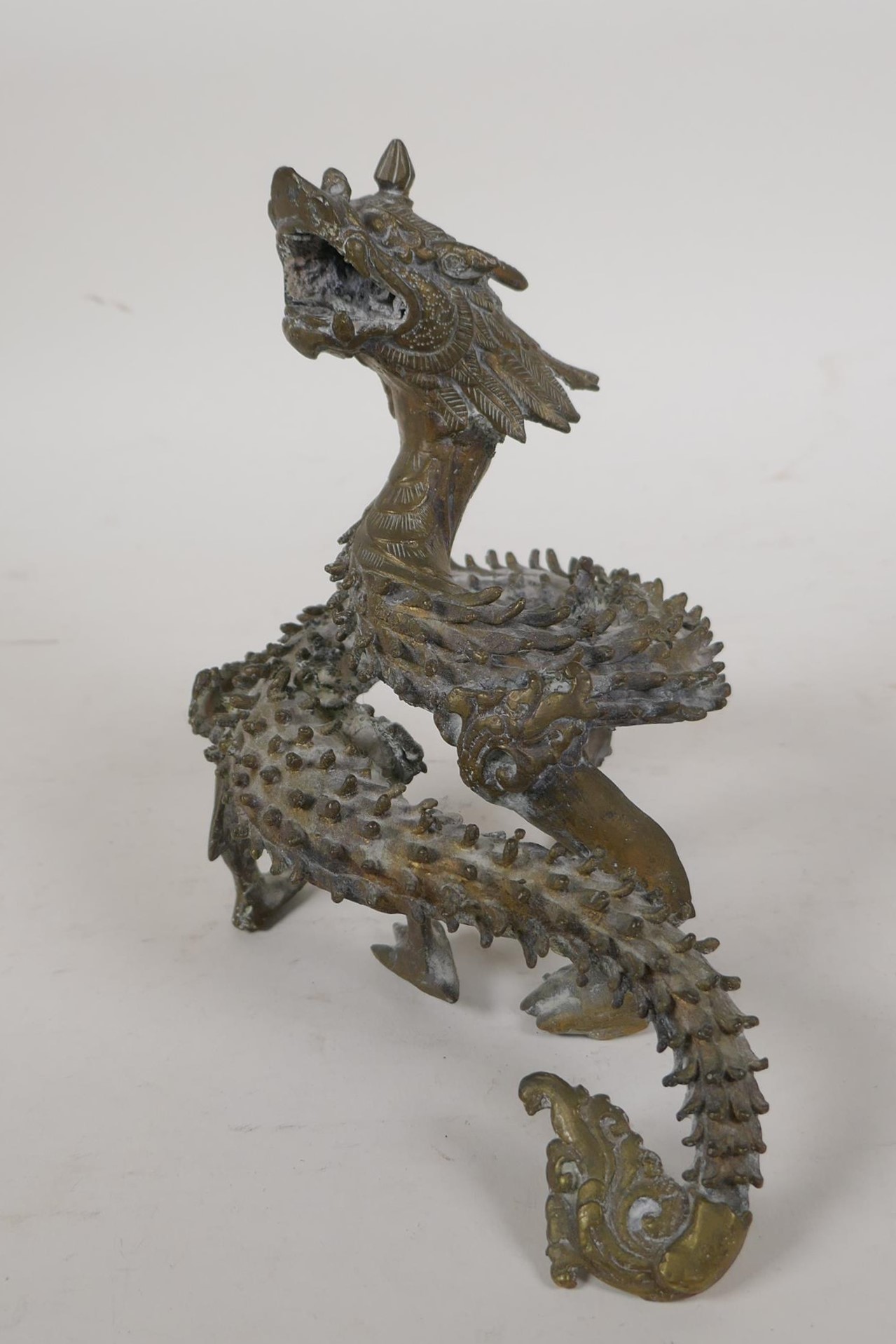 An Oriental cast brass figure of a Spiney dragon in coiled pose, 7" high - Image 4 of 4