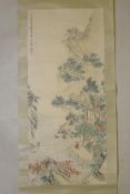 A Chinese watercolour scroll depicting figures in a riverside dwelling, 21½" x 49"