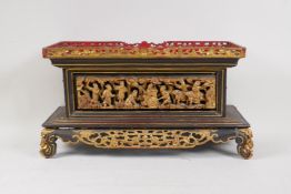 An antique Chinese carved and pierced, gilt and lacquer wood stand decorated with industrious