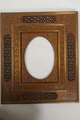 An Anglo Indian hardwood photo frame with pierced and brass inlaid decoration, aperture 6" x 8",