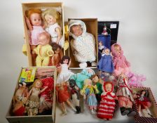 A collection of small vintage dolls and costumes