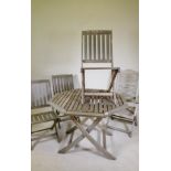 A folding teak garden table and four folding chairs, one AF