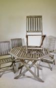 A folding teak garden table and four folding chairs, one AF